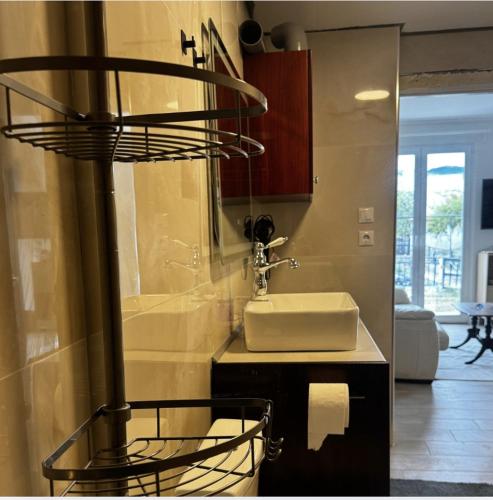 a bathroom with a sink and a mirror and a sink at Villa Katerinaki in Kos