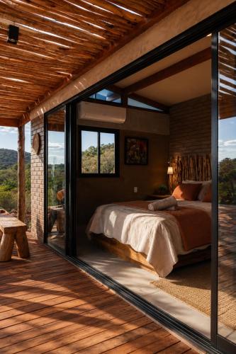 a bedroom with a large bed and a large window at Sertão do Luar in Jurubeba