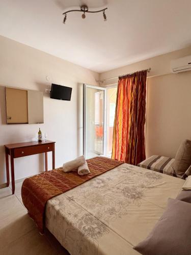 a bedroom with a large bed and a window at Marie Claire Studios in Olympic Beach