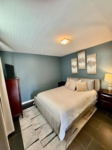 a bedroom with a bed and a blue wall at Maxine Manor in Douglasville