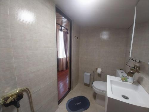 a bathroom with a toilet and a sink and a shower at Tamila Guest House in Kazbegi