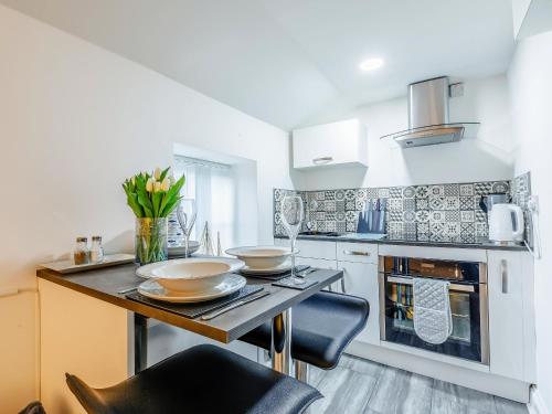 a kitchen with a table with two bowls on it at Lake View-Uk34414 in Cheddar