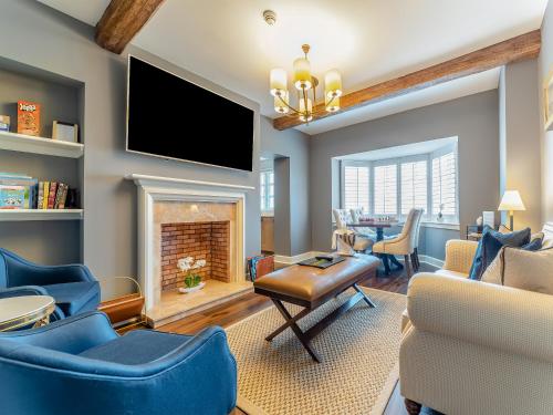 a living room with blue chairs and a fireplace at Royal Aberdeen - Ukc6917 in Turnberry