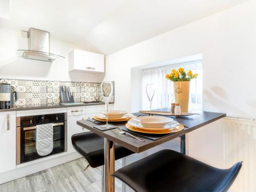 a kitchen with a table with plates on it at Tor View-Uk34415 in Cheddar