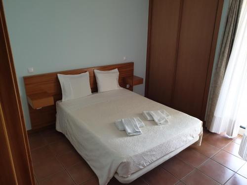 a bedroom with a bed with two towels on it at Gerês maravilha in Geres