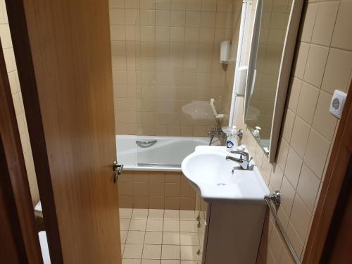 a bathroom with a sink and a bath tub at Gerês maravilha in Geres