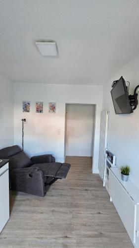 a living room with a couch and a tv at Schönes Apartment in Verl in Verl