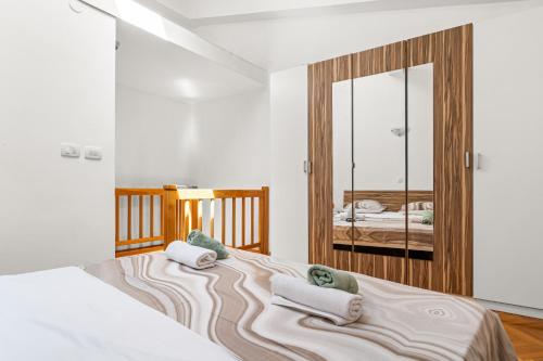 a bedroom with a bed with towels on it at Apartment old Town in Lovran
