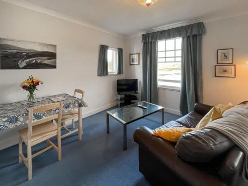 a living room with a couch and a table at Avocet Apartment - Uk51130 in Carradale