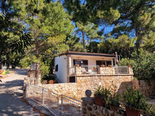 a stone house with a fence in front of it at Villa Mala in Zavala