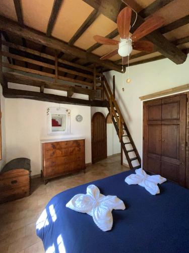 a bedroom with a blue bed with two towels on it at Eclissi casa vacanza LUNA in Casalini