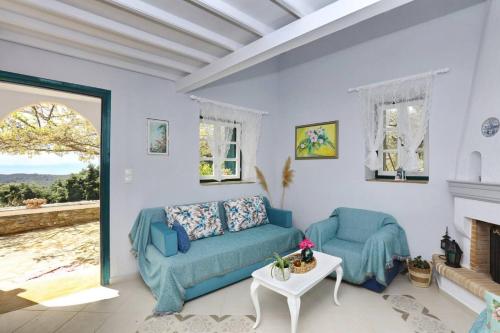 a living room with a couch and a fireplace at Villa Potami in Agnontas