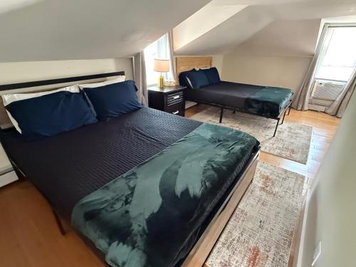 a bedroom with a large bed and a couch at Oakland Beach Cottage - Sleeps up to 4 in Warwick