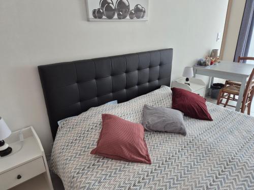 a bedroom with a bed with two pillows on it at Les Lauriers in Espondeilhan