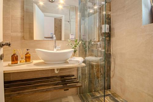 a bathroom with a sink and a shower at Summer Nights Resort in Ipsos