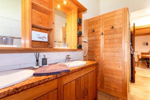 a bathroom with a sink and a mirror at Loderbichl Alm Ferienwohnungen in Lofer