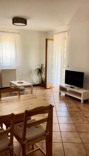 a living room with a table and a tv at Al Monte Zelo in Agordo