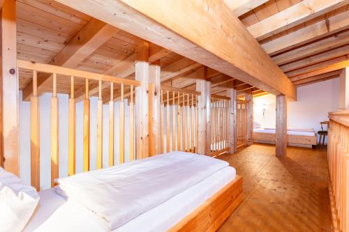 a bedroom with a bed in a wooden room at Loderbichl Alm Ferienwohnungen in Lofer