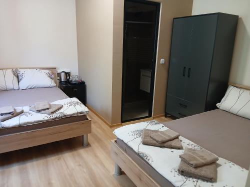 a bedroom with two twin beds and a cabinet at Sofija apartments in Gevgelija