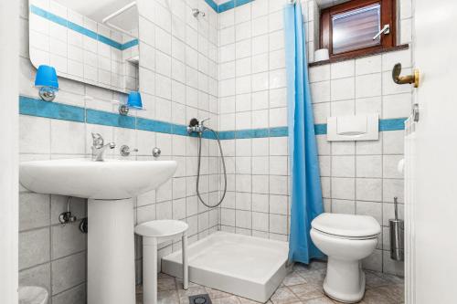 a bathroom with a sink and a toilet and a shower at Villa Lili in Lovran