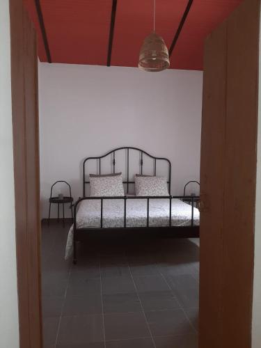 a bedroom with a bed in a white wall at Casinha Serrinha in Mértola