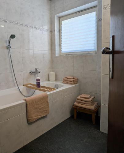 a bathroom with a tub and a sink and a window at Mitzi's Zauberblick in Landeck