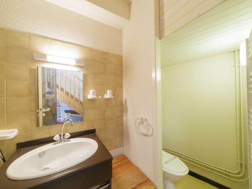 a bathroom with a sink and a toilet and a mirror at Appartement avec mezzanine pour 4, vue sur Gourette - FR-1-400-49 in Gourette