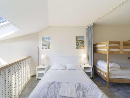 a bedroom with a bed and bunk beds at Appartement avec mezzanine pour 4, vue sur Gourette - FR-1-400-49 in Gourette
