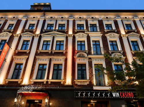 a large building with many windows on a street at Hotel Centrum Sosnowiec in Sosnowiec