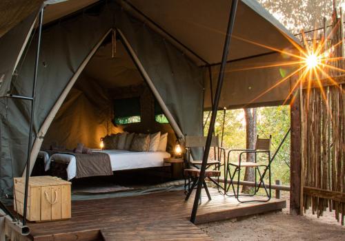 a bedroom in a tent with a bed in it at Bundox Explorer Camp in Hoedspruit