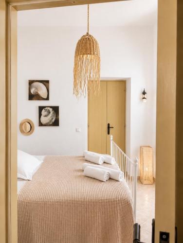a bedroom with a bed with towels on it at Lemonia House in Vívlos