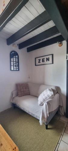 a room with a couch in the corner of a room at Duplex le Randonneur - Les Apparts du Sancy in Chastreix