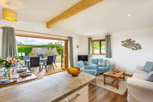 a kitchen and living room with a couch and a table at L54 - Sunny Corner in Truro