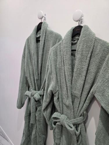 a robe hanging on a rack in a room at Gîte de la Daudière La Grange in Le Boupère