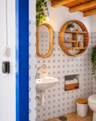 a bathroom with blue and white tiles and a sink at Lemonia House in Vívlos
