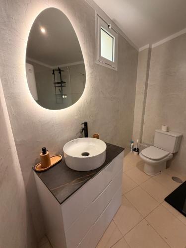 a bathroom with a sink and a mirror at relax by the sea in Puerto de Santiago