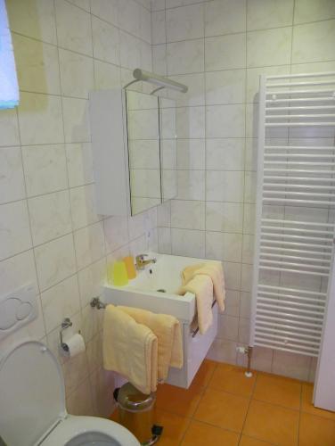 a white bathroom with a sink and a mirror at Ferienwohnung Ski-Hans in Planneralm