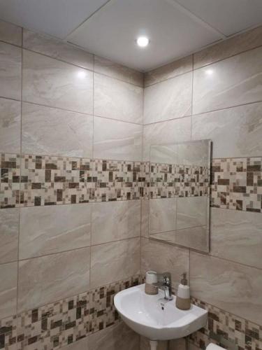 a bathroom with a sink and a mirror at Вила Рея in Sinemorets