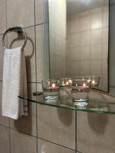 a glass table with candles on it in a bathroom at Beach Hive 2 in Walvis Bay