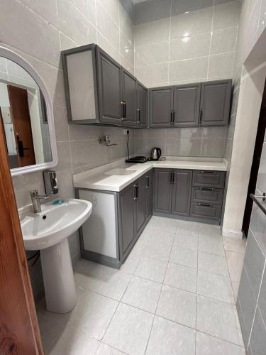 a bathroom with a sink and a toilet and a sink at سرور للشقق المخدومة in Al Baha