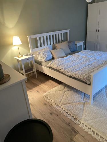 a bedroom with a bed and a table with a lamp at Chalupa jako domov in Kolín
