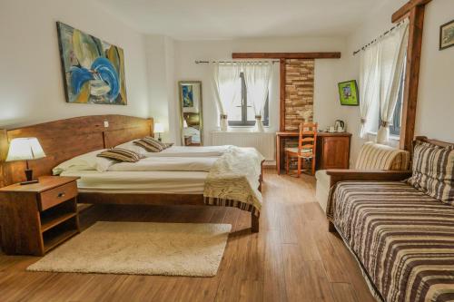 a bedroom with a bed and a couch at Green Garden Plitvice lakes in Plitvica Selo