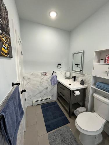 a bathroom with a toilet and a sink at Modern & Spacious Apartment 15 Min to NYC Near MetLife & American Dream in Jersey City