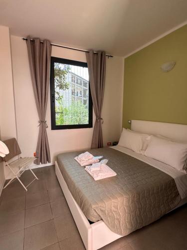 a bedroom with a large bed and a window at Borgo&Lago Home in Castro