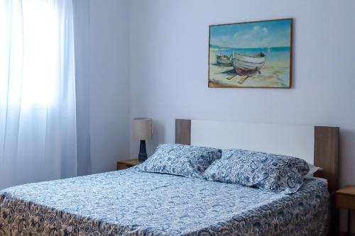 a bedroom with a bed and a painting on the wall at Apartment Stella in Vis