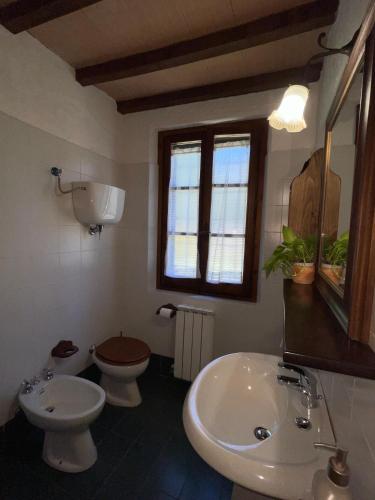 a bathroom with a white sink and a toilet at Eclissi casa vacanza SOLE in Casalini
