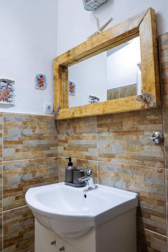 a bathroom with a sink and a mirror at Apartment Stella in Vis