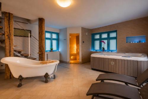 a large bathroom with a tub and a sink at Dovolenkový dom Čerešňový Sad in Vysoké Tatry