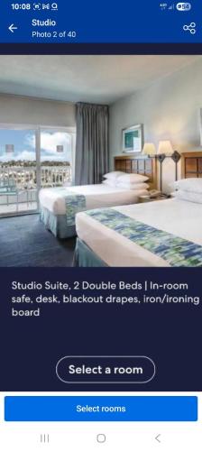 a screenshot of a hotel room with two beds at Dorado Del Mar Beach Resort in Dorado