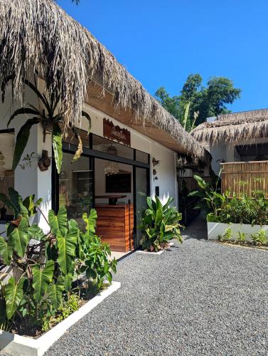 a building with a large glass door and some plants at Maison PAYAPA PORT BARTON in San Vicente